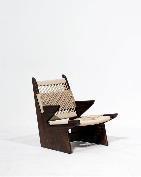 Modern chair with wooden frame and woven seat on a white background. 
