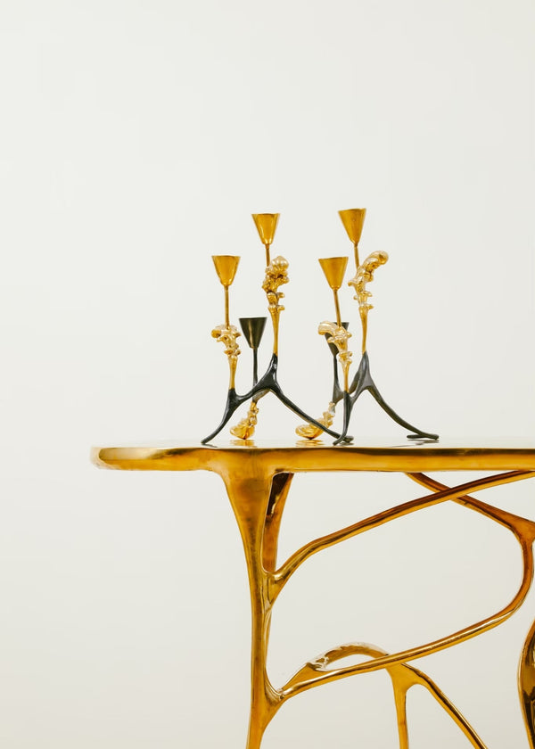 Candle holders on brass table.