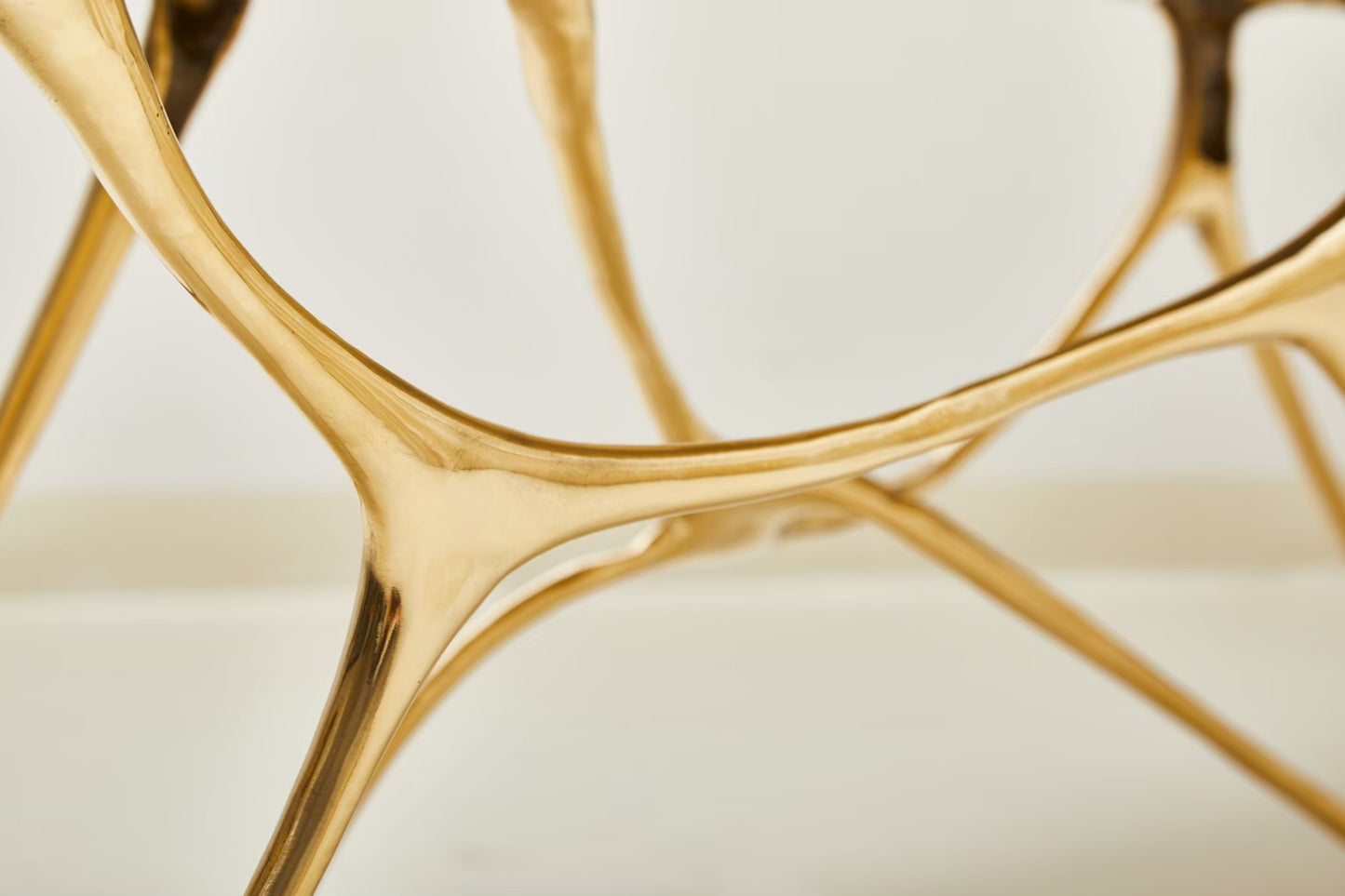 zoom in detail of leg of gold brass bench. 