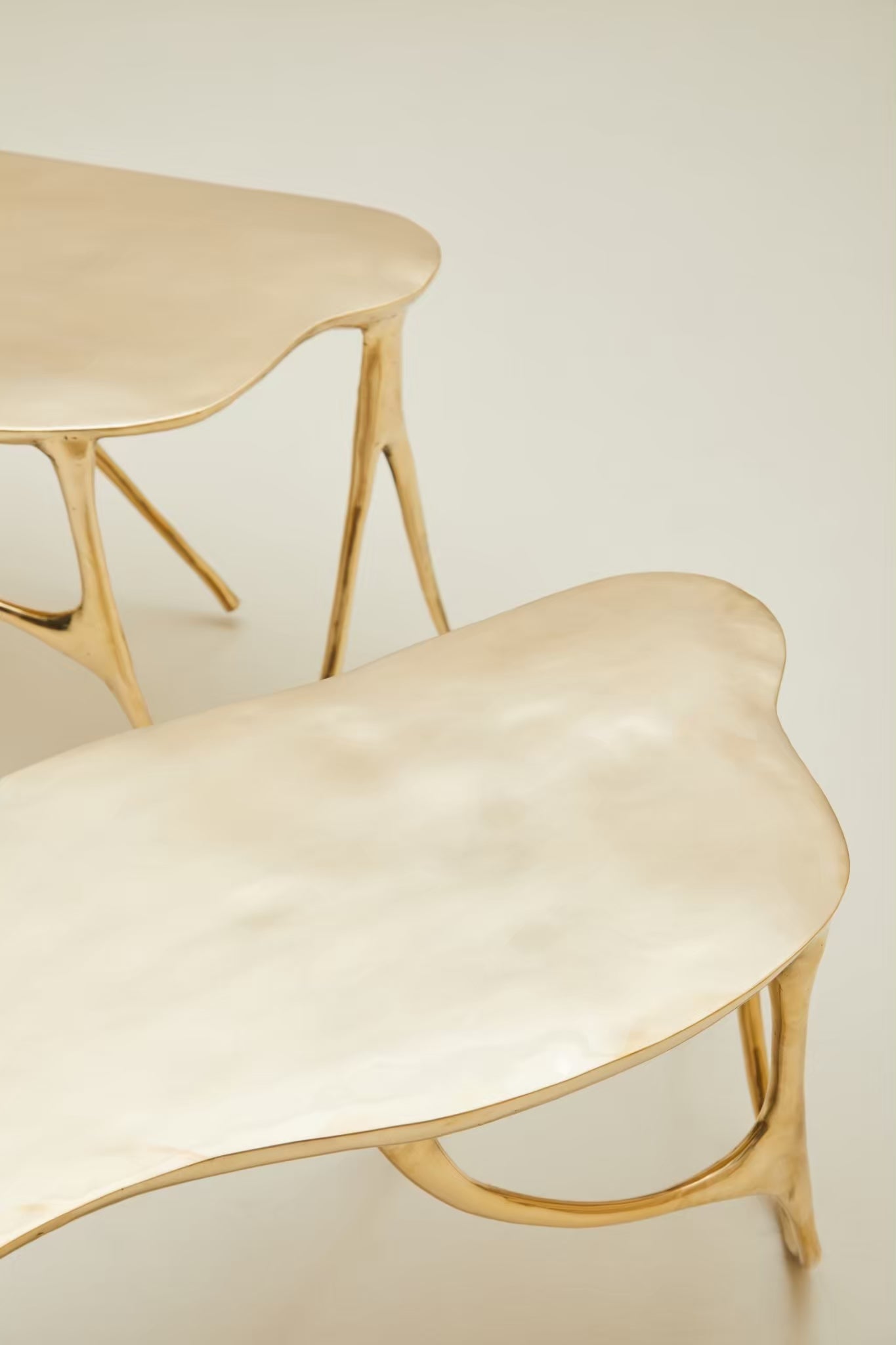 zoom in detail of leg of gold brass bench. 