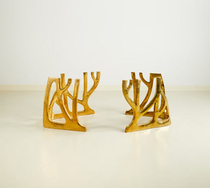 Modern gold metal table base with an organic, branching coral-like silhouette, displayed on a clean white surface against a white background.