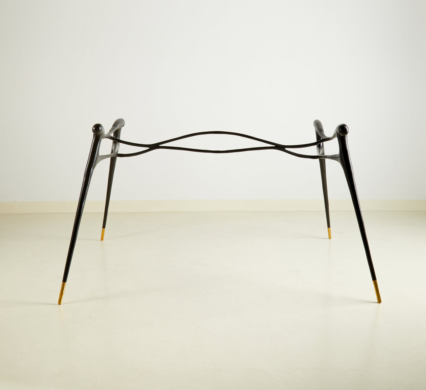 Minimalist black brass table on a white background