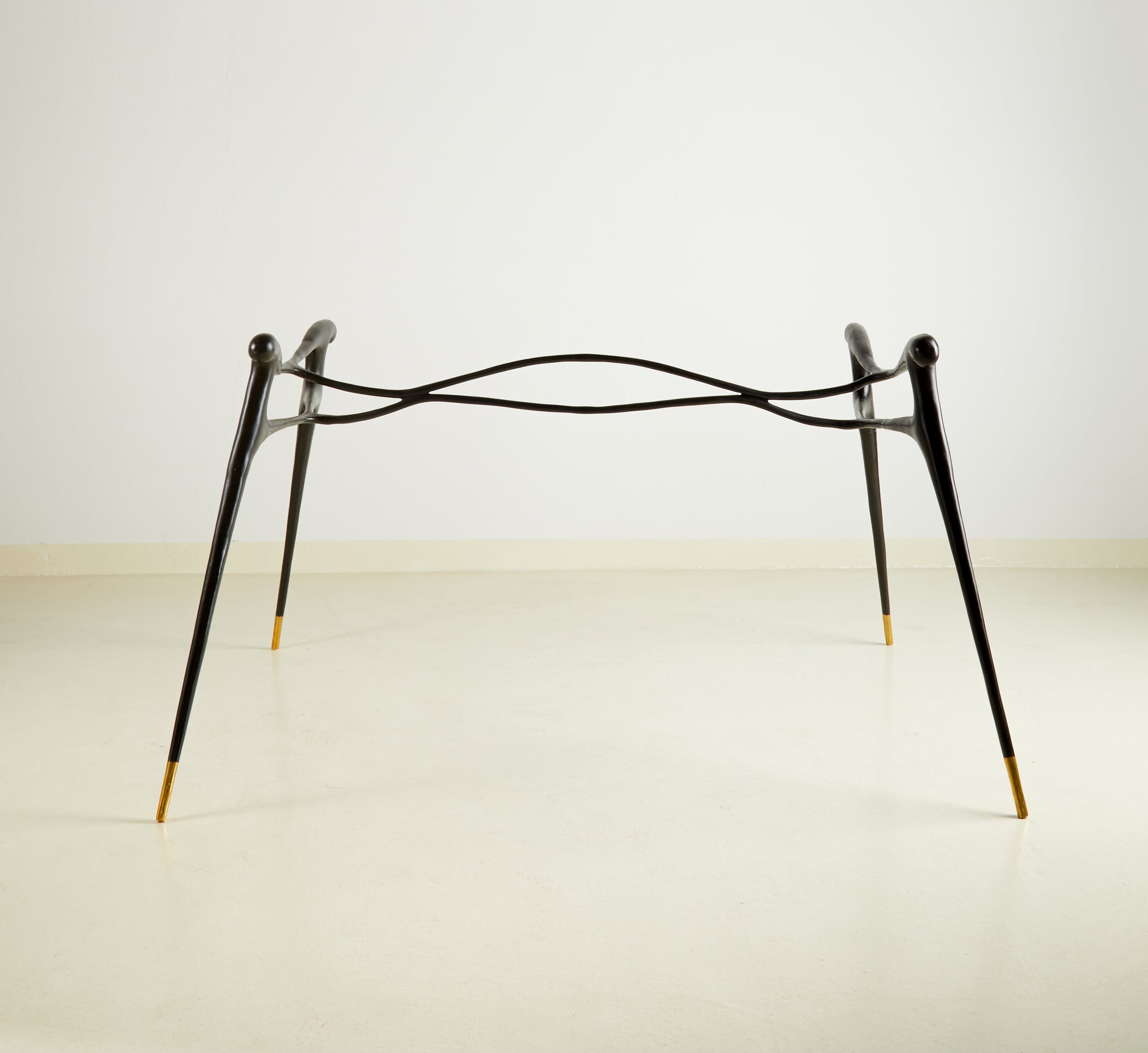 Minimalist black brass table on a white background