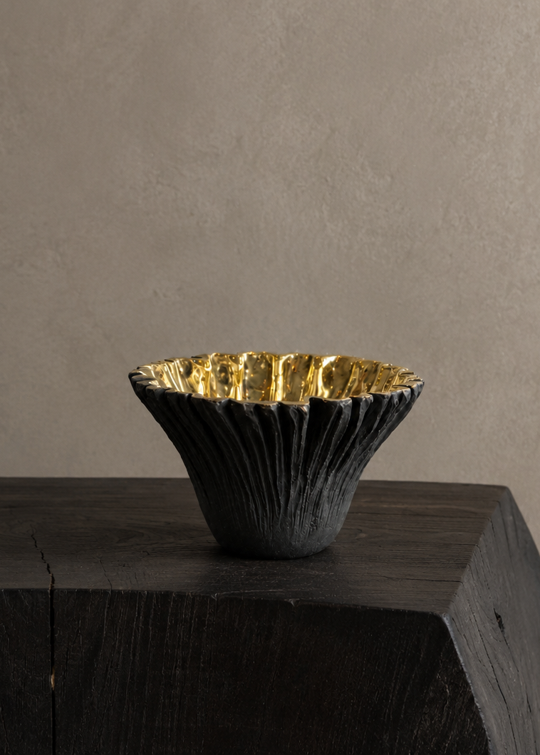 Black ruffled with gold interior brass bowl. Hight point view. 