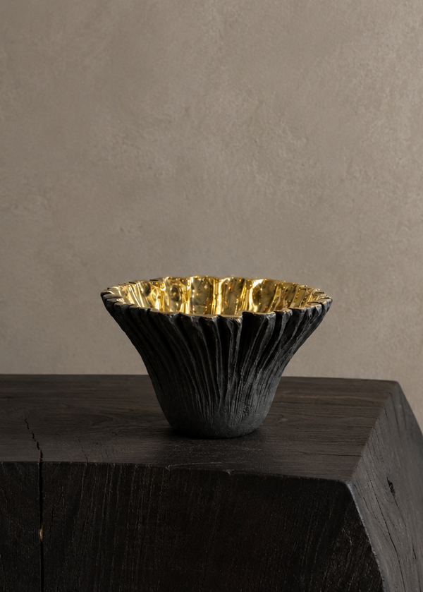 Black ruffled with gold interior brass bowl. Hight point view. 