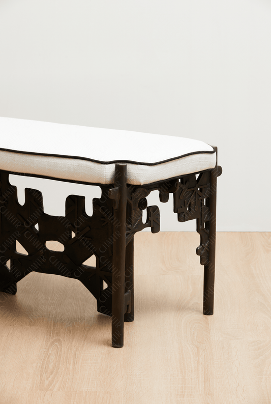 Brass luxury handmade furniture bench with white cushioned seat, ideal for modern luxury decor, against a white wall. zoomed in