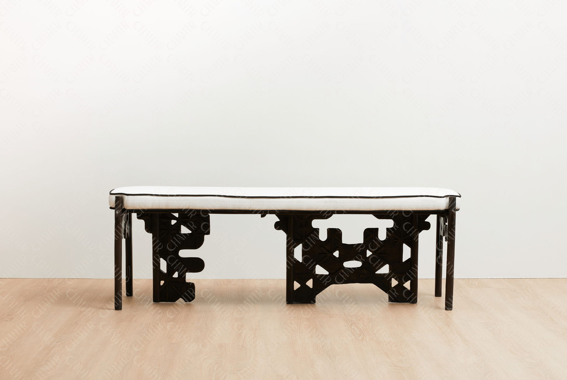 Brass luxury handmade furniture bench with white cushioned seat, ideal for modern luxury decor, against a white wall. straight angle