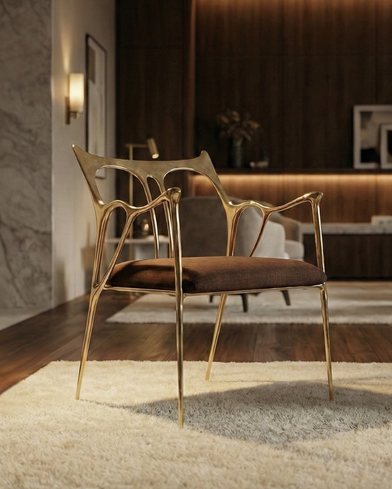 Sumi Studio Chair with brown cushion. Sculptural frame with gold finish. Click to view product. 