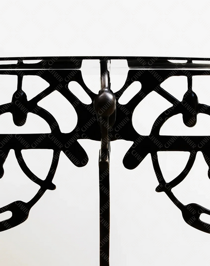 Decorative black brass base with intricate design on a white background
