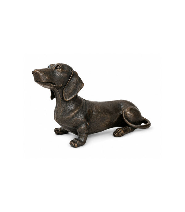 Bronze statue of a dachshund on a white background