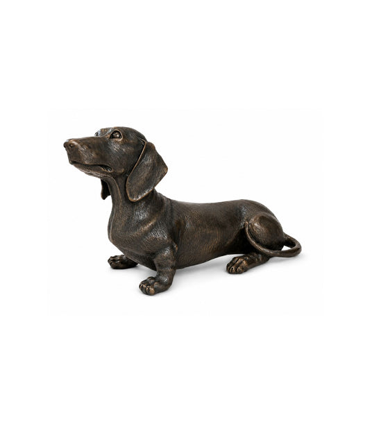 Bronze statue of a dachshund on a white background