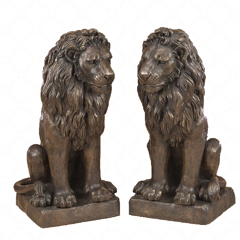 Two bronze luxury handmade furniture lion statues in a sitting pose, perfect for modern luxury decor, on a white background.