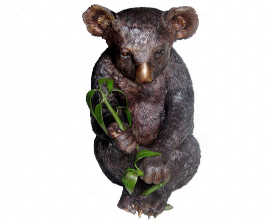 Luxury handmade furniture statue of a koala bear holding a branch, perfect for modern luxury decor, on a white background