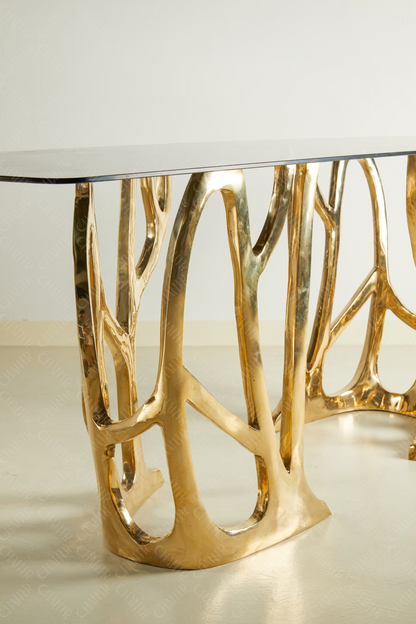 Zoomed in - Gold brass luxury handmade furniture console table with glass top, perfect for modern luxury decor, on a white background