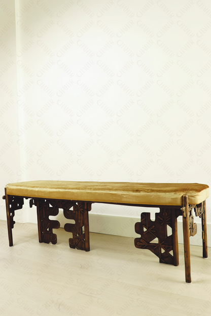 Brass luxury handmade furniture bench with cushioned seat, ideal for modern luxury decor, against a white wall.