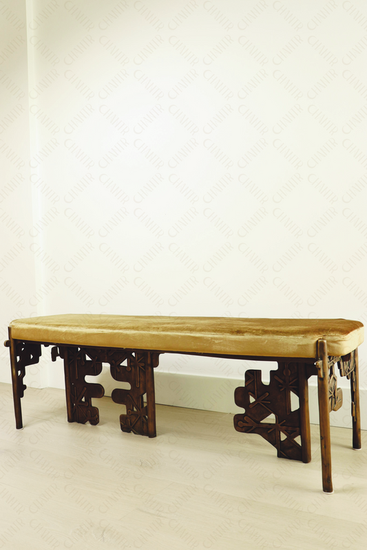 Brass luxury handmade furniture bench with cushioned seat, ideal for modern luxury decor, against a white wall.