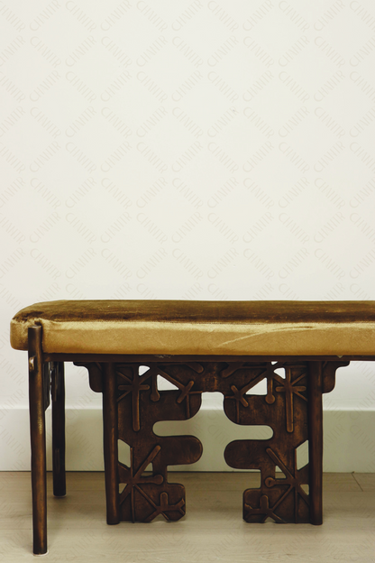 half of Brass luxury handmade furniture bench with cushioned seat, ideal for modern luxury decor, against a white wall.