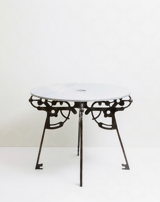 Round luxury handmade furniture table with white marble top and decorative black brass legs, ideal for modern luxury decor, on a white background.