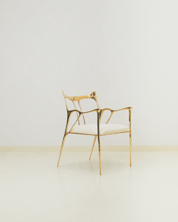 Luxury handmade brass chair with gold finish and white cushion on white background. 