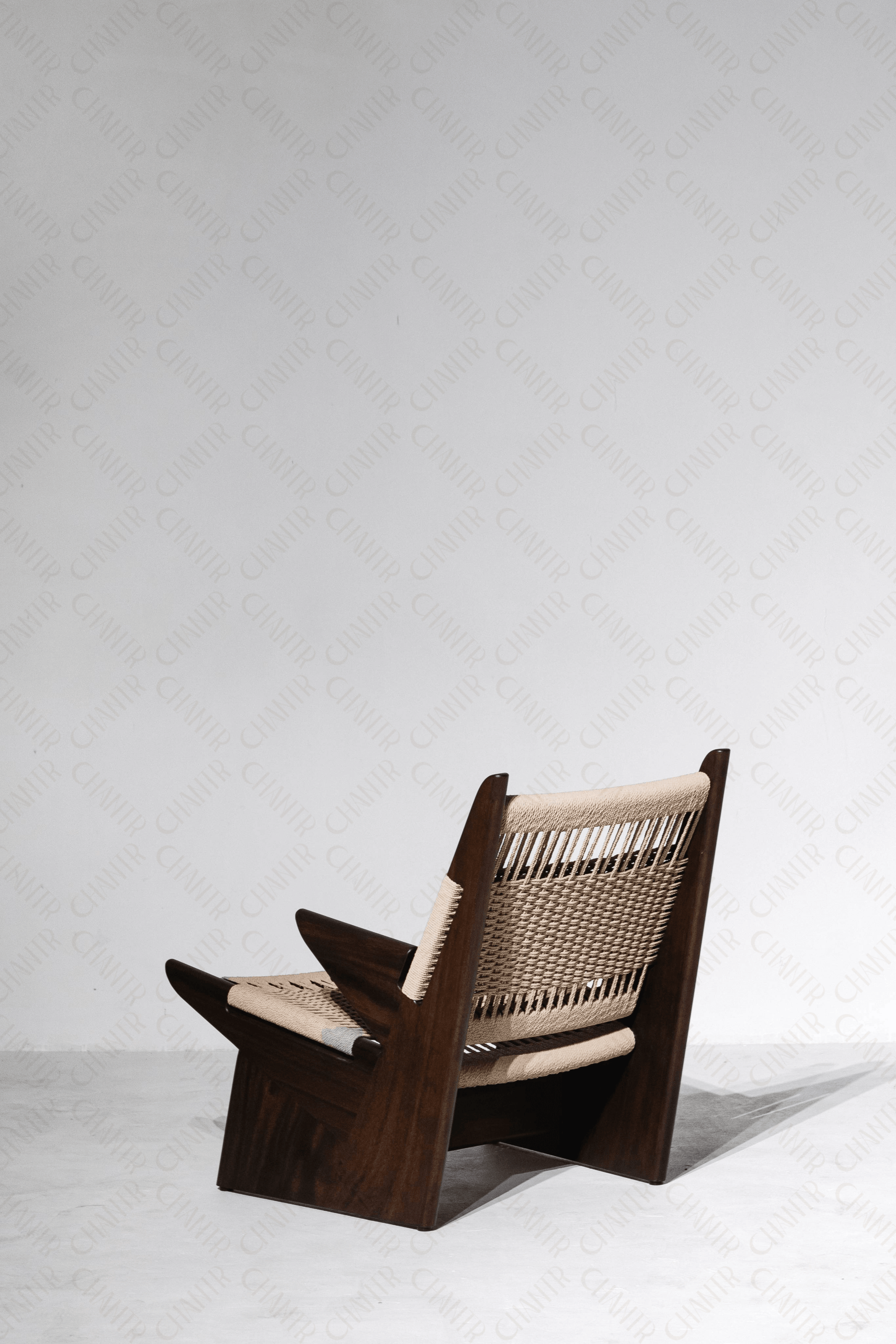 half back facing angle - Woven luxury handmade furniture chair with acacia wood frame, perfect for modern luxury decor, on a white background.