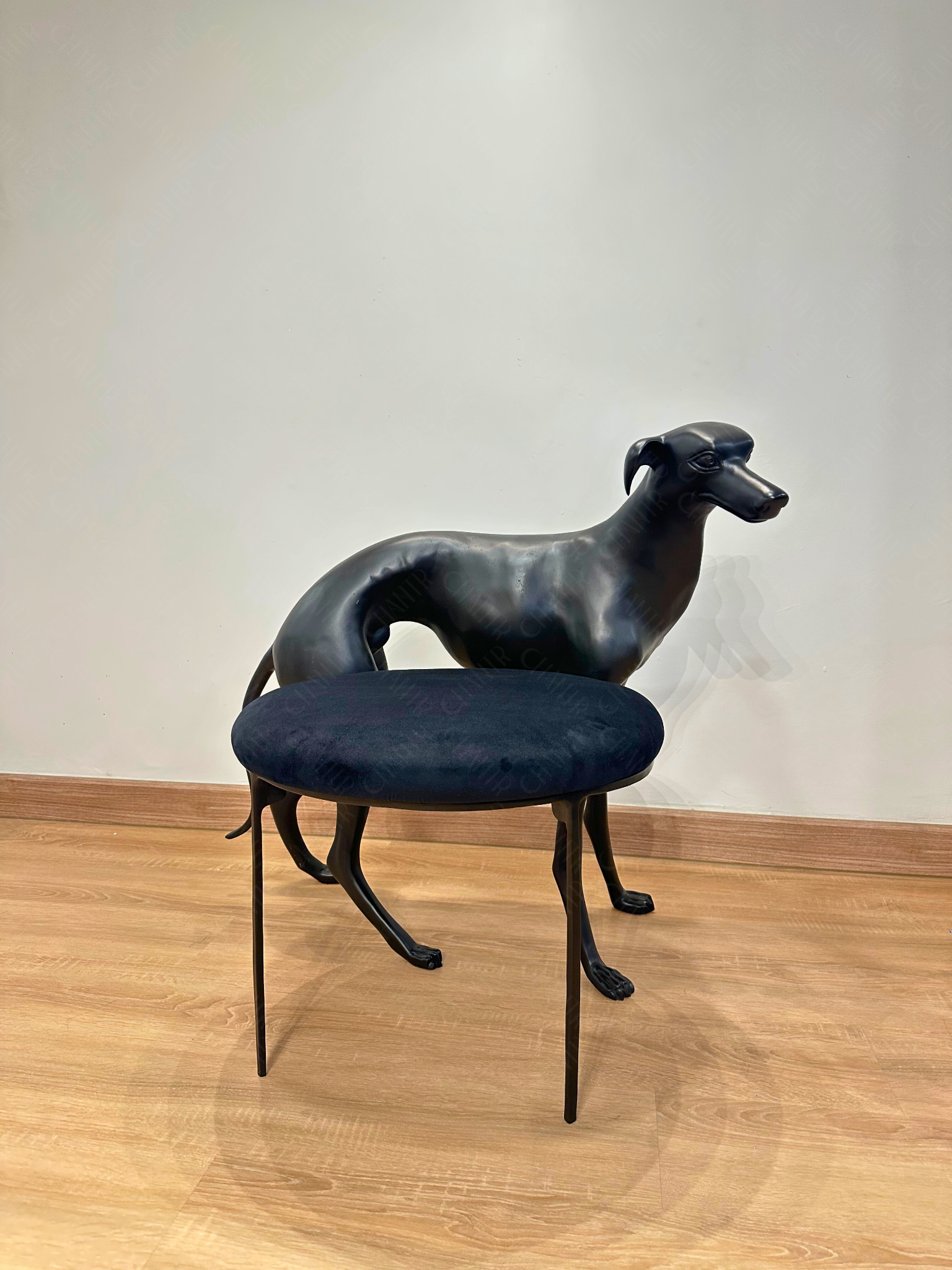 Black dog-shaped chair with a black cushion on a wooden floor. Luxury Modern Furniture