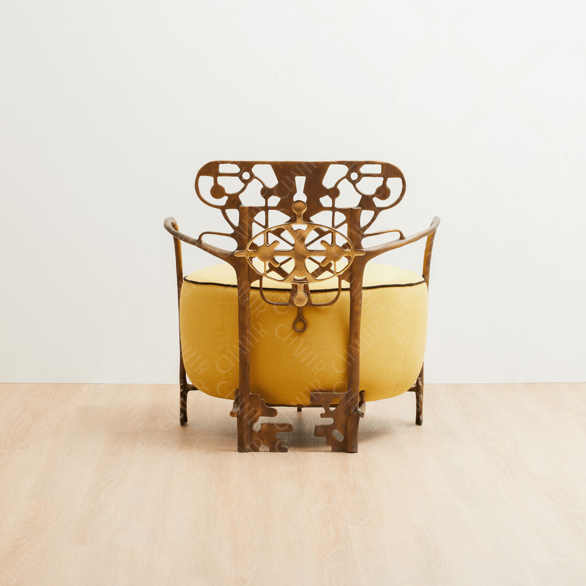 Decorative gold brass luxury handmade furniture chair with intricate metal frame, and yellow cushion ideal for modern luxury decor, on a white background. - back angle