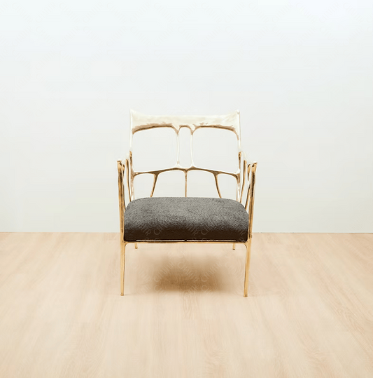 Gold brass luxury handmade furniture armchair with textured gray cushion, ideal for modern luxury decor, on a beige floor with white wall background. straight angle