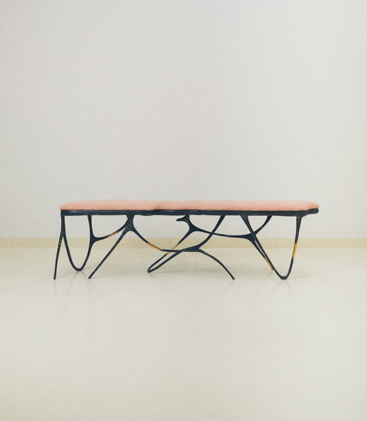 Modern luxury handmade furniture coffee table with black metal frame and pink top, brass furniture accents, perfect for modern luxury decor, on a plain background.