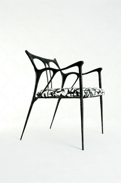 Black brass luxury handmade furniture chair with patterned cushion, ideal for modern luxury decor, on a wooden floor.