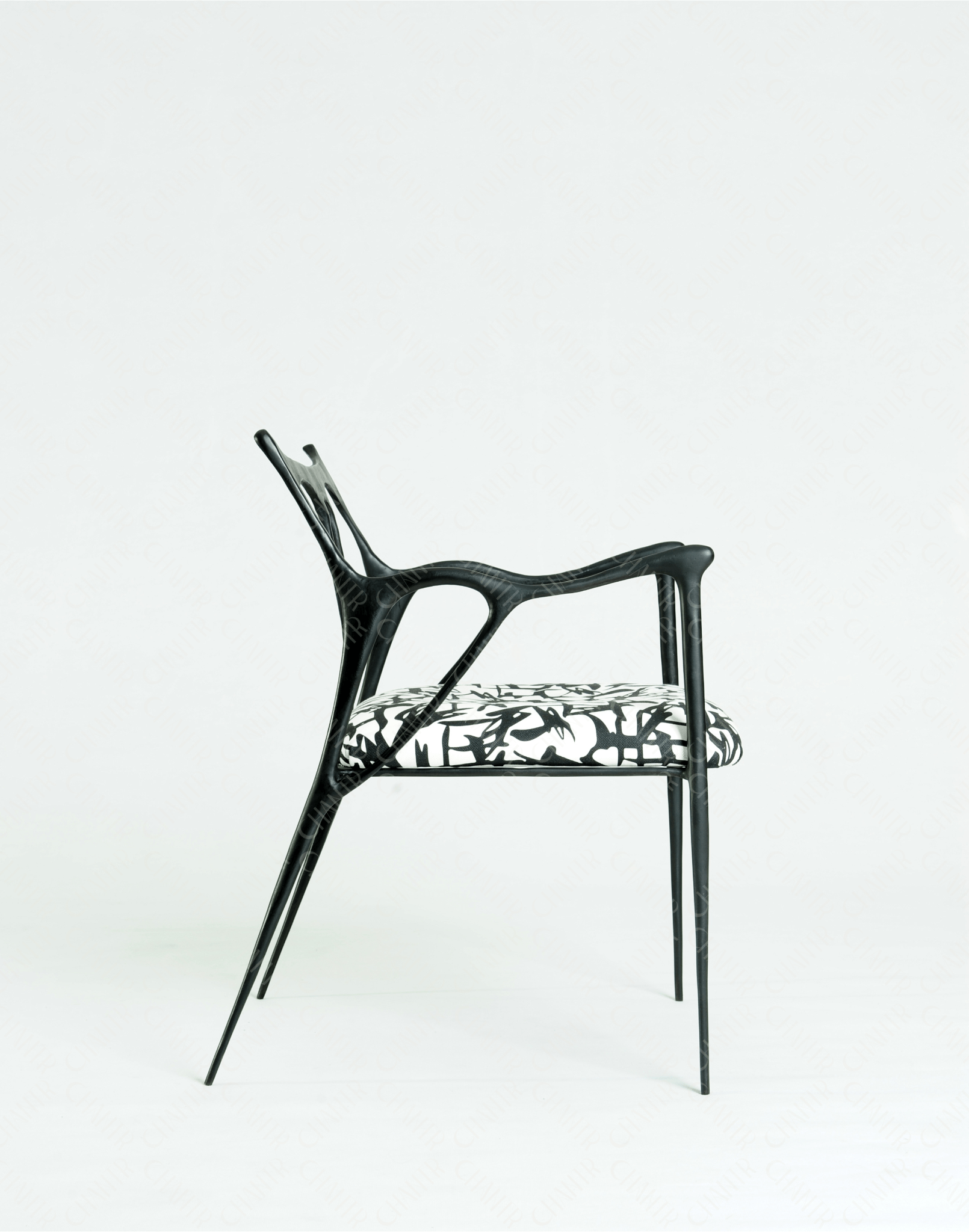 Black brass luxury handmade furniture chair with patterned cushion, ideal for modern luxury decor, on a wooden floor.