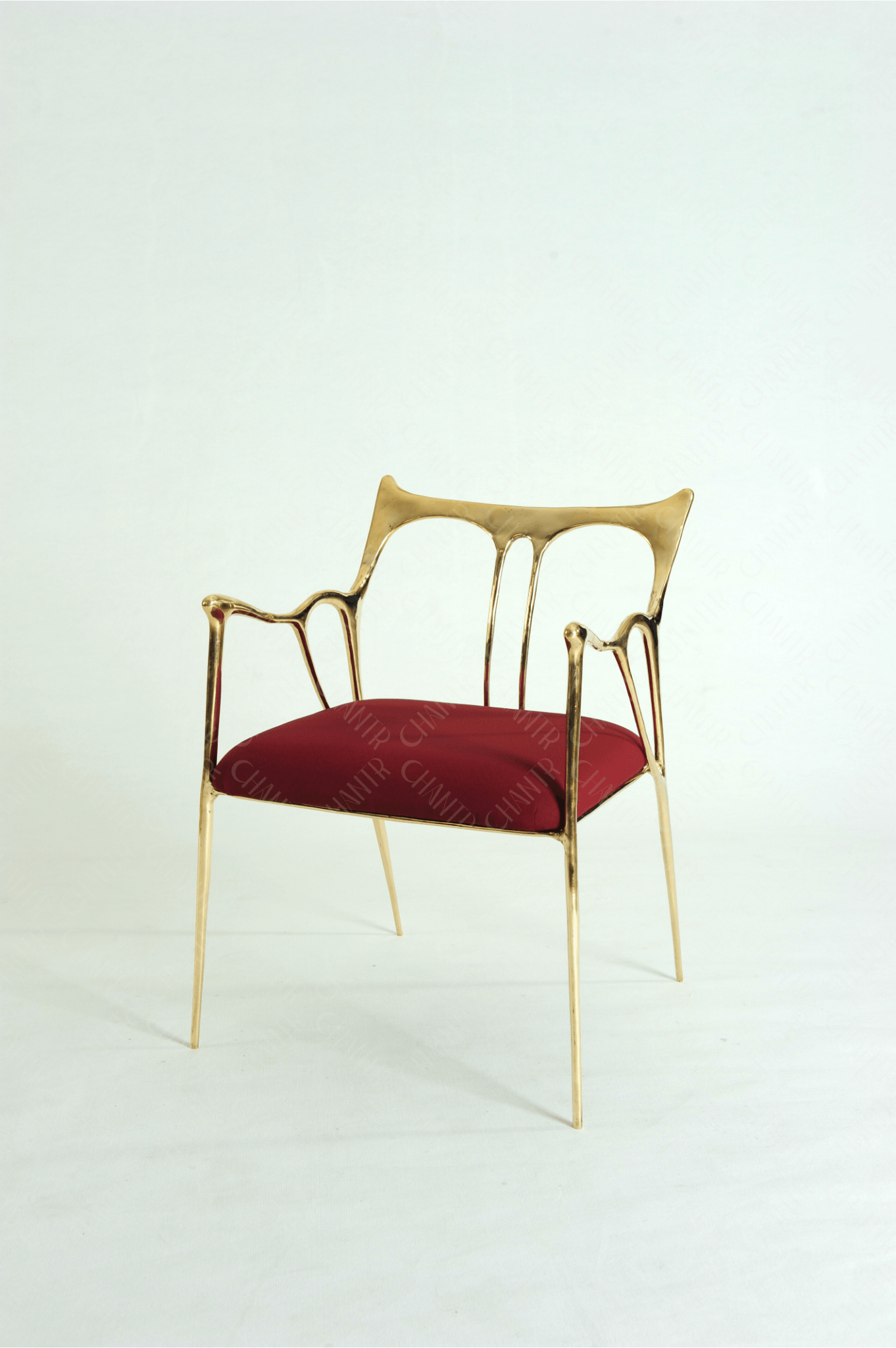 Gold brass luxury handmade furniture chair with red cushion, ideal for modern luxury decor, on a wooden floor.