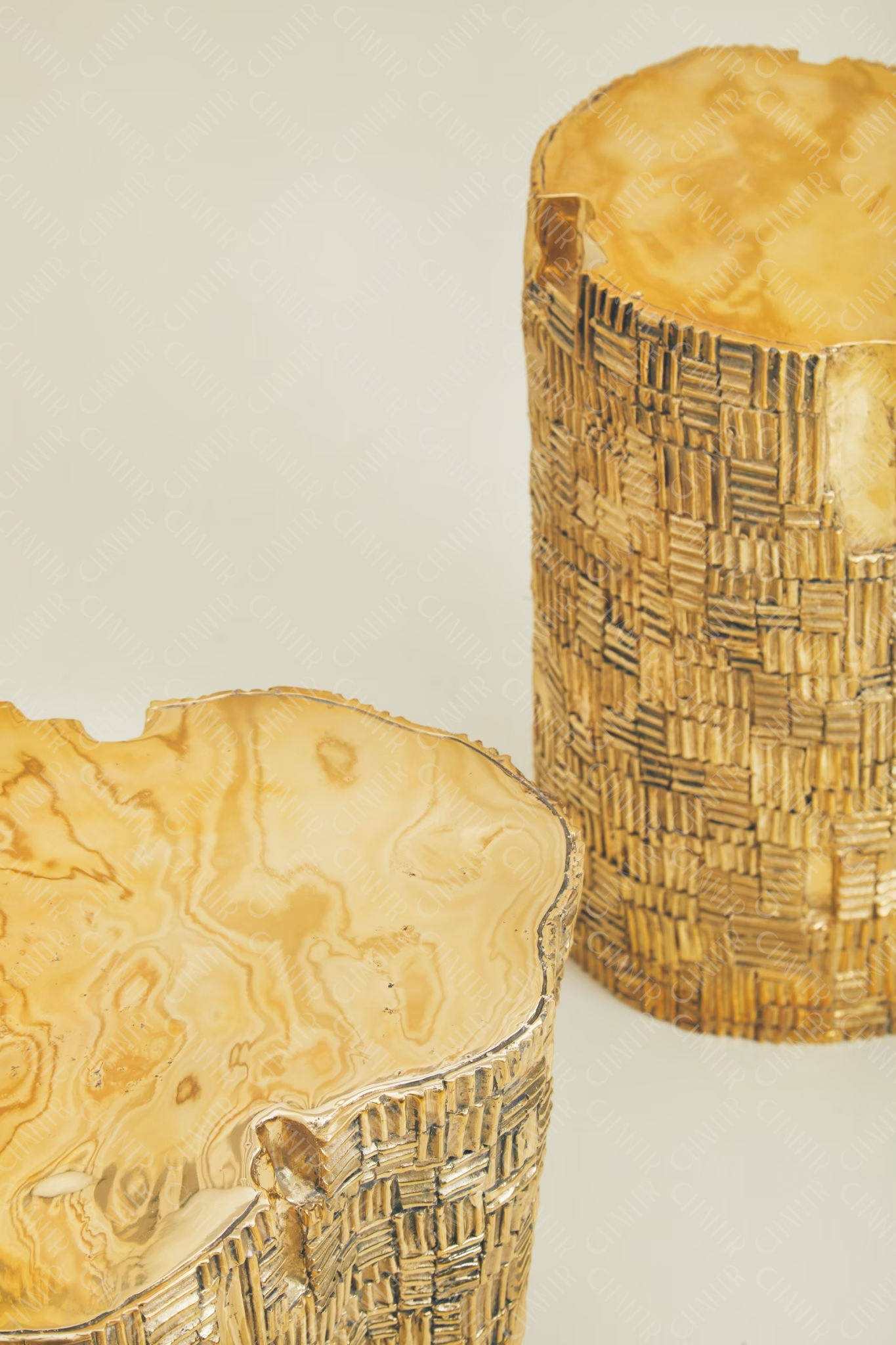 Two brass and modern luxury decor with textured surfaces on a light background