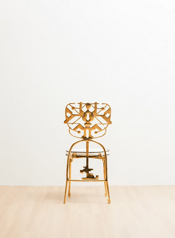 Gold chair with intricate design on a white background. Luxury handmade furniture. Back angle
