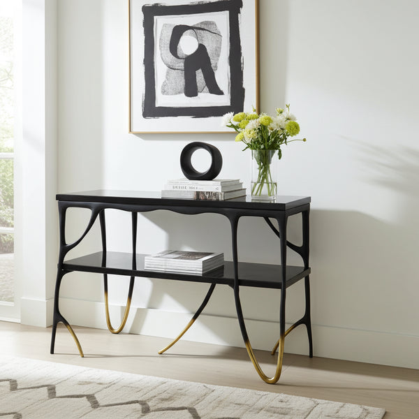 two tiered console table with gold tips and two black marble tops in a modern living room.