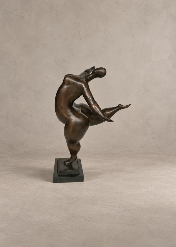 A bronze sculpture of a dancing lady in an abstract, stylized pose, mounted on a dark rectangular base against a neutral textured beige background.
