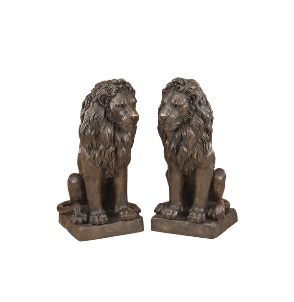 Two bronze luxury handmade furniture lion statues in a sitting pose, perfect for modern luxury decor, on a white background.
